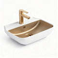 Gold oval ceramic sink with a stylish faucet for modern bathrooms